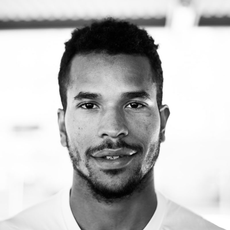 grayscale photo of man wearing Nike shirt